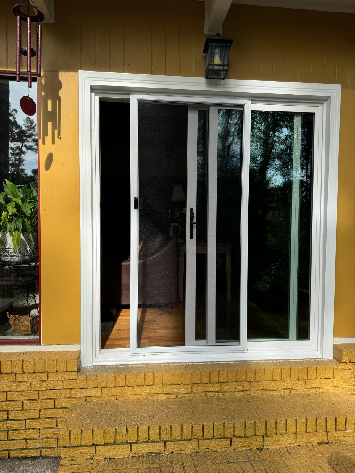 New sliding patio door installed in a brick opening