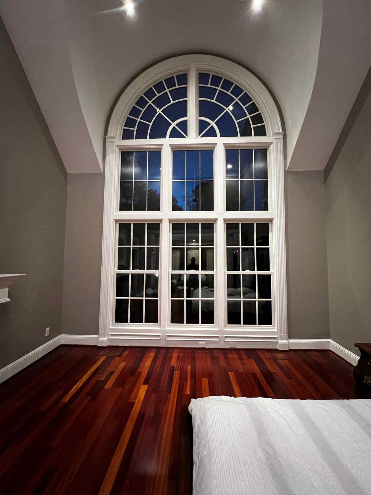 Finished custom arch-top window with grid pattern in Fuquay-Varina, NC