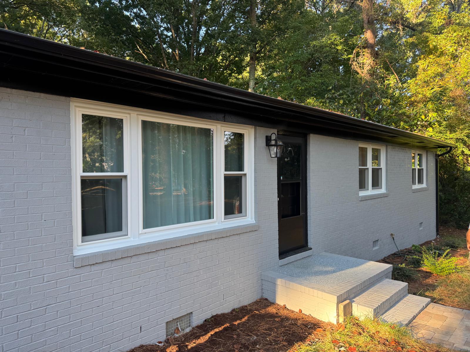 Brick ranch home in Fuquay-Varina, NC with newly installed white replacement windows